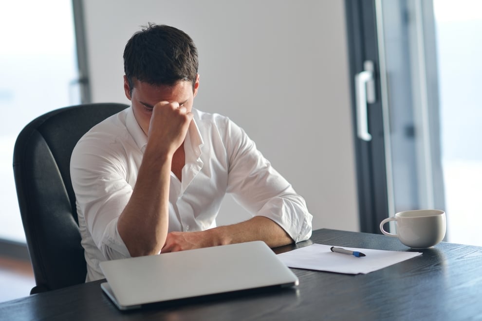 frustrated with problems young business man working on laptop computer at home-1